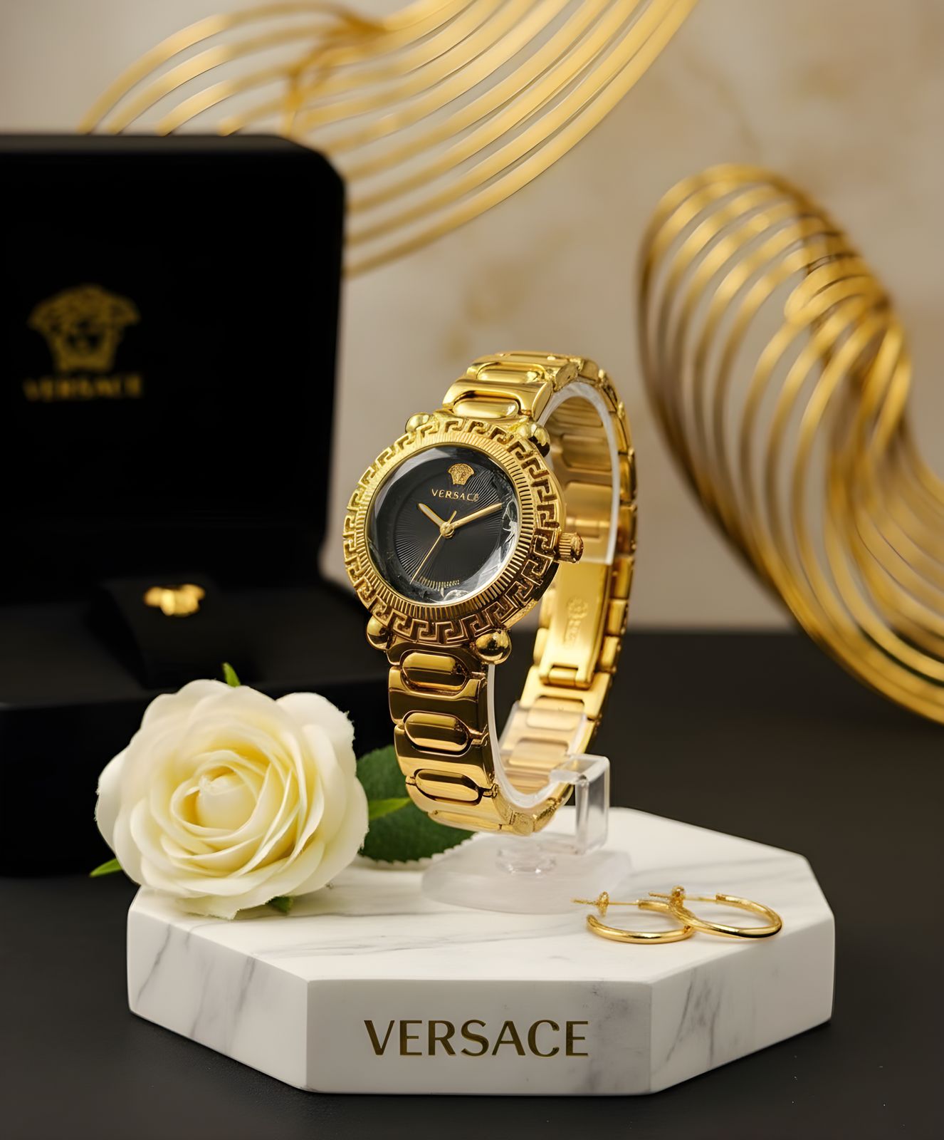 Versace Women’s Gold Watch — A luxurious timepiece with a gold stainless steel bracelet and a black round dial. Designed with Versace’s iconic Greek key pattern, it perfectly combines elegance and bold style for any occasion.